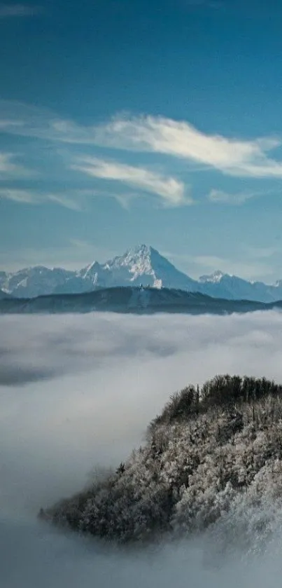 Mountain view with misty clouds and blue sky wallpaper.