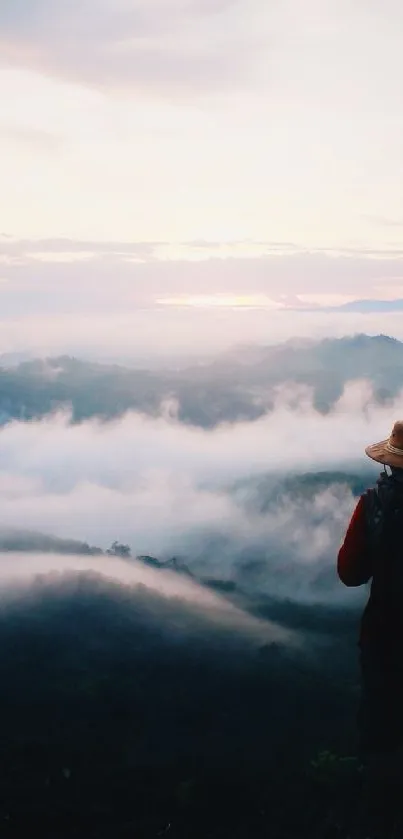 Silhouette of a traveler with mountain and clouds at sunrise.