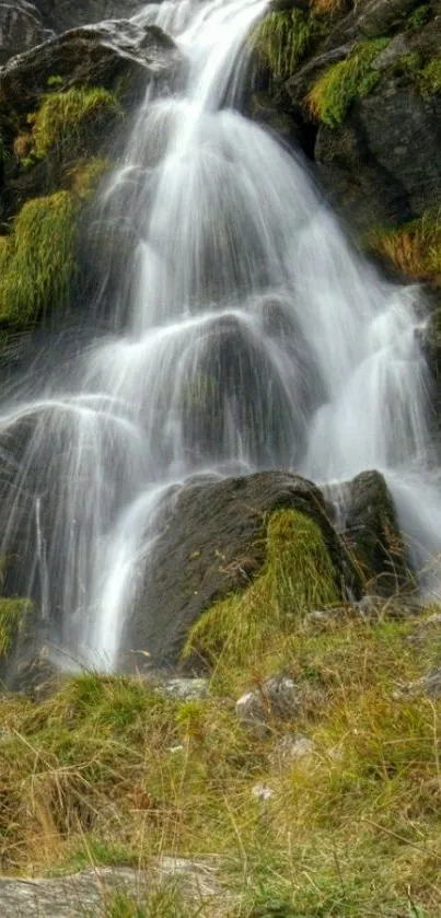 A serene mountain waterfall amid greenery.