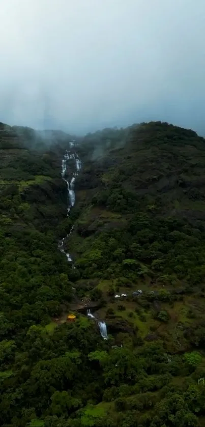 A serene mountain scene with a cascading waterfall.