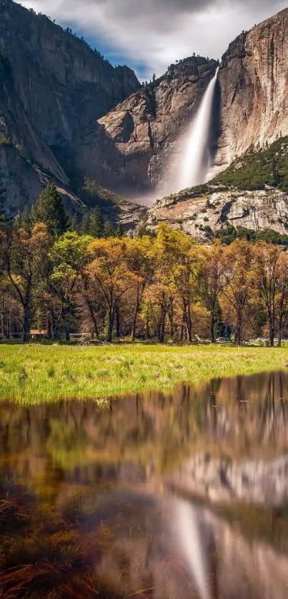 Scenic view of waterfall with lush greenery and mountain backdrop.