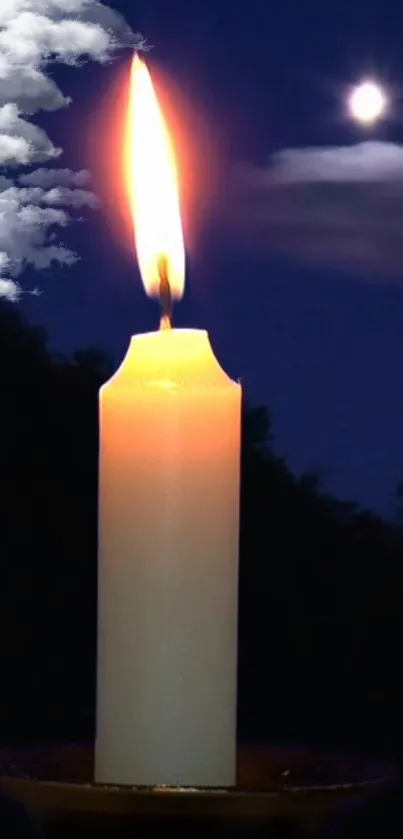 Candle glowing softly under a moonlit night sky with scattered clouds.