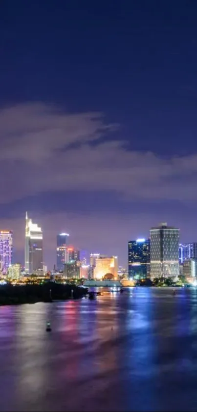 Serene night cityscape with illuminated skyline and reflections.