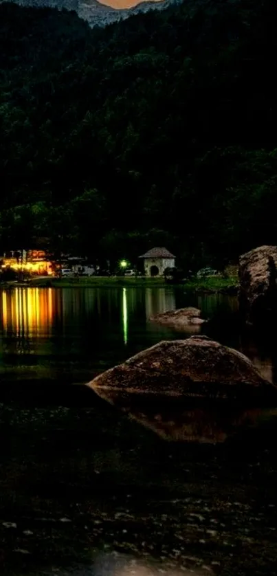 Serene night view of a lake with mountains.