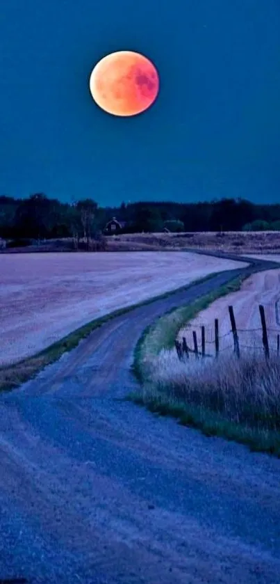 Blood moon over a dark blue rural landscape wallpaper.