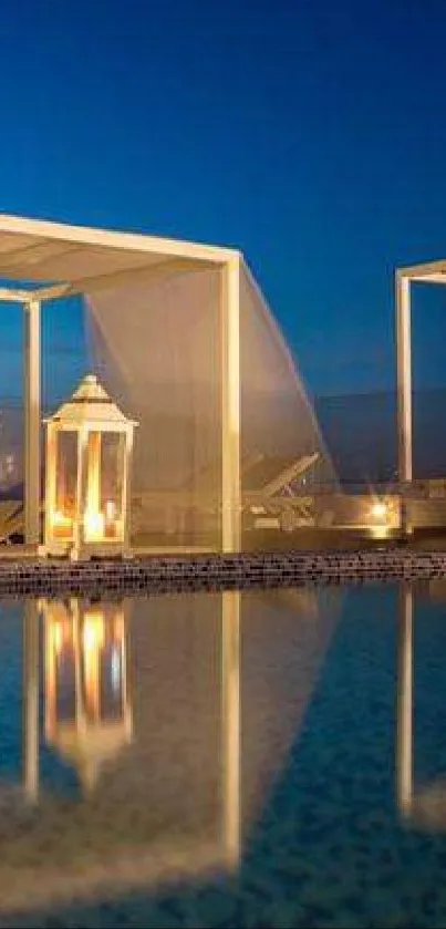 Serene poolside with lanterns under a midnight blue sky.