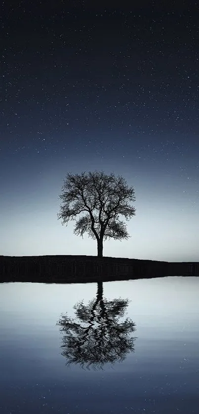 Lone tree reflected on calm water under a starry night sky.