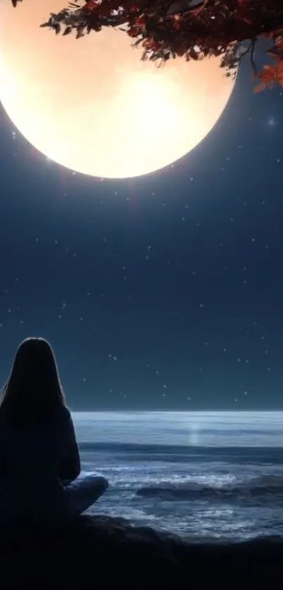 Woman sits by ocean under glowing full moon and starry sky at night.