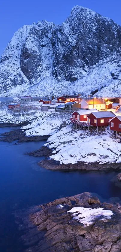 Snowy Nordic coastal scene with blue mountains.