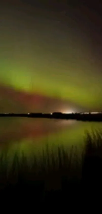 Northern lights over a tranquil lake at night with a vivid aurora display.