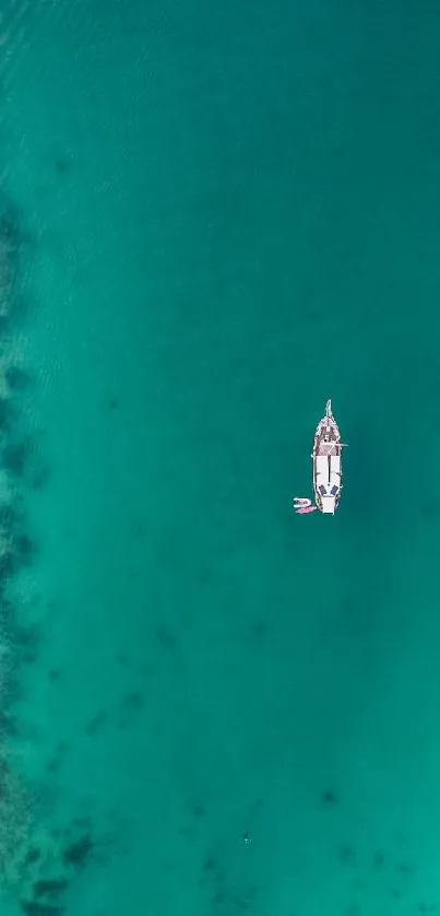 Aerial view of a boat in turquoise ocean waters.