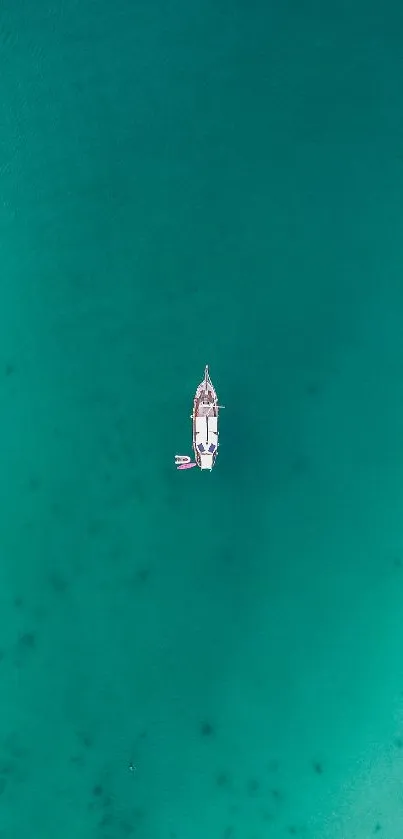 Aerial view of a boat in turquoise ocean waters.