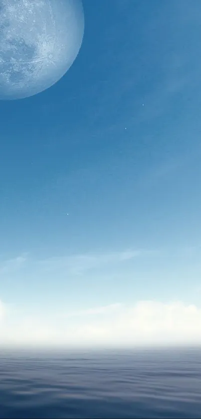 Tranquil ocean under a serene blue sky with a prominent moon.