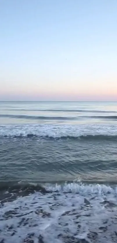 Serene ocean waves at sunset with a calm horizon view.