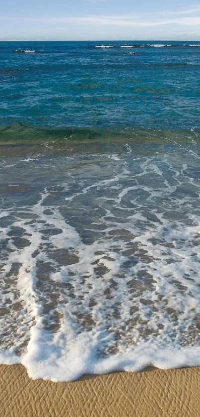 Ocean waves gently crashing on a sandy beach.