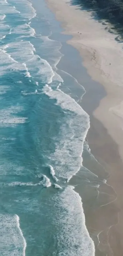 A serene view of turquoise ocean waves meeting sandy beach.