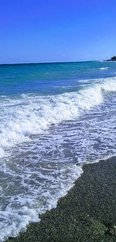 Serene ocean view with blue waves crashing on the beach shore.