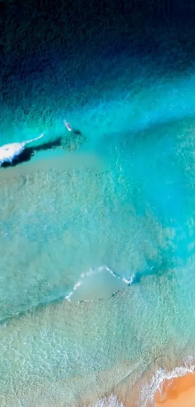 Aerial view of ocean waves with vibrant turquoise and sandy beach.