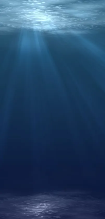 Tranquil blue ocean depth wallpaper with light rays.