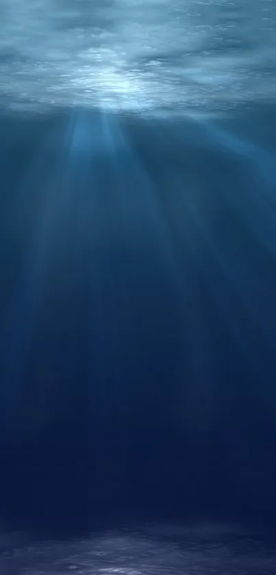 Serene ocean depth wallpaper with blue hues and light rays penetrating water surface.