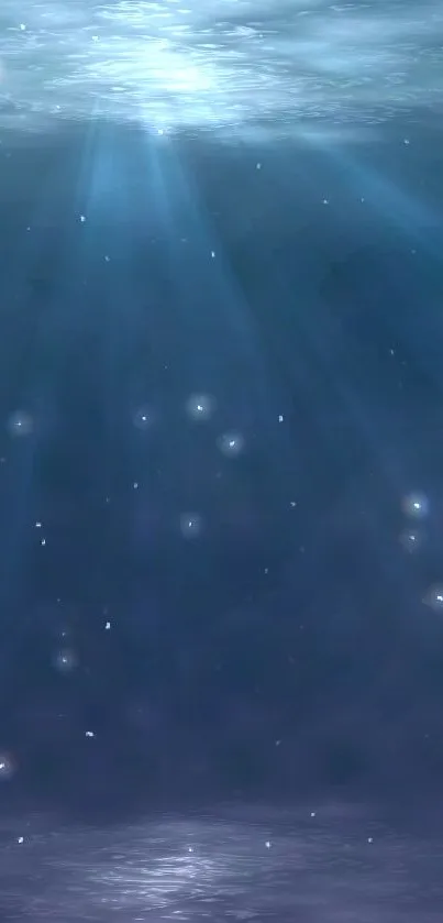 Serene ocean depths wallpaper with light rays penetrating water.