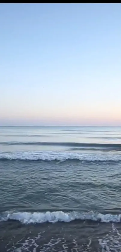 Serene ocean horizon with calm sea and pastel sky for mobile wallpaper.