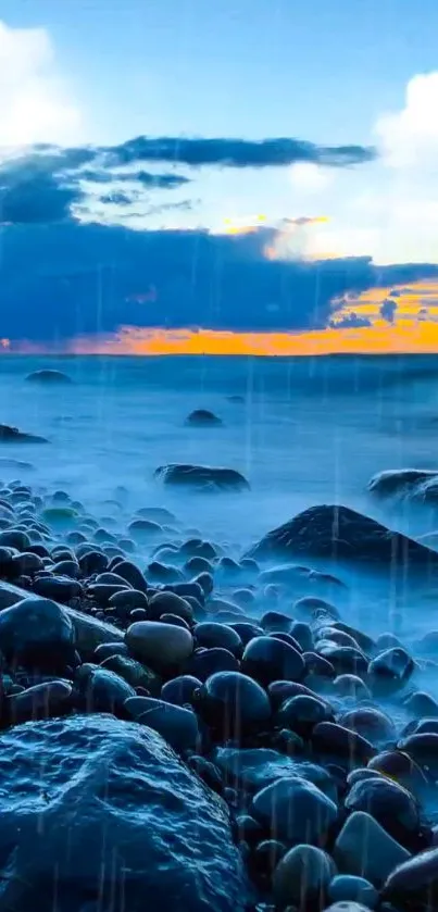 Calm ocean with pebbles at sunset, vibrant blue sky.