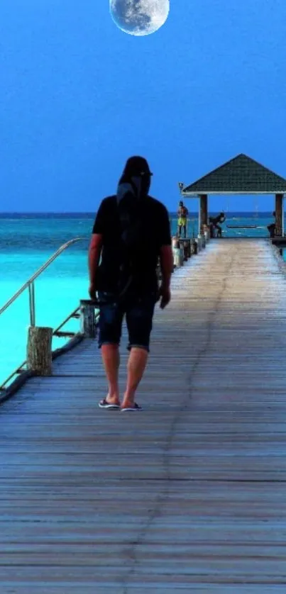 Nighttime view of a man walking on a serene ocean pier, under a bright moon.