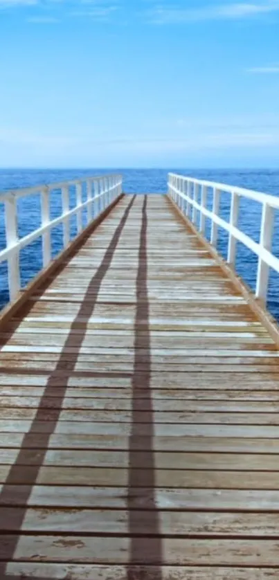 Serene ocean view from a wooden pier with blue skies.