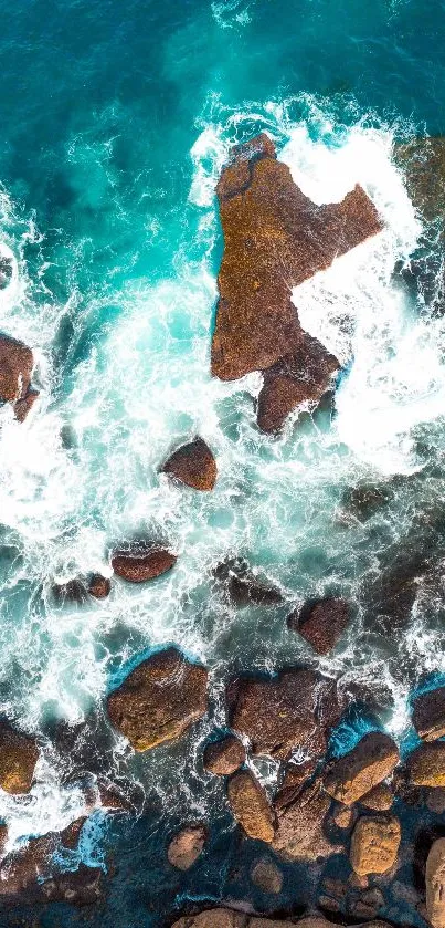 Aerial view of ocean waves crashing against rugged rocks.