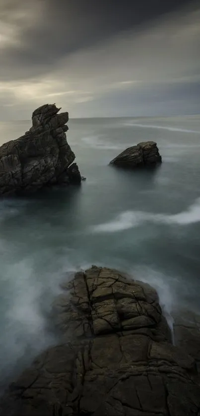 Serene seascape with dramatic rocks and calm ocean waves.