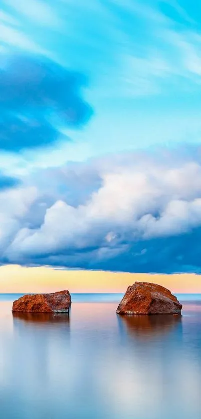 Serene ocean scene with rocks and blue sky.