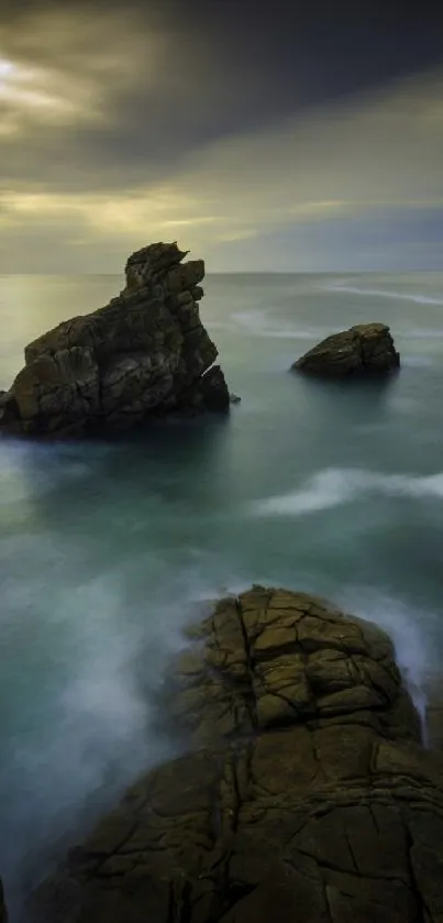 Serene ocean rockscape with sunset glow.