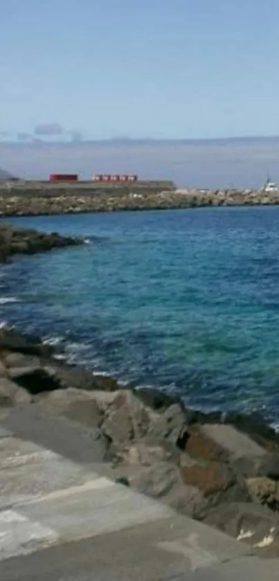 Serene ocean view with rocky shoreline and vibrant blue waters.