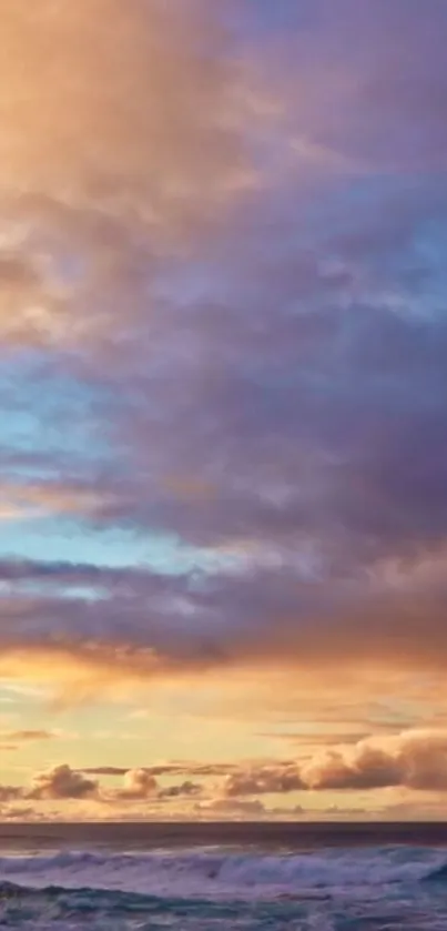 Vibrant sunset sky over a calm ocean with clouds in orange and blue hues.