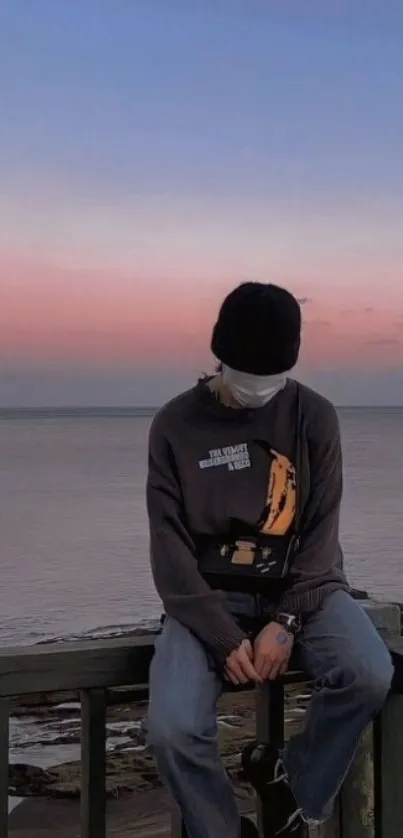 Serene sunset view with ocean and solitary figure.