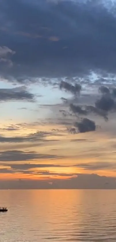 Tranquil ocean sunset with vibrant sky reflecting on calm waters.