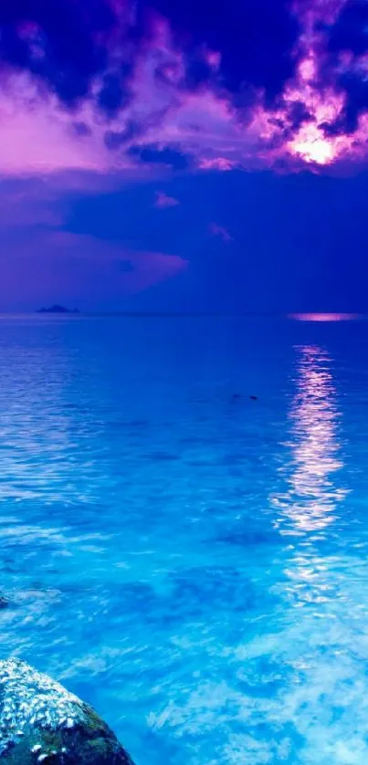 Serene ocean sunset with vibrant blue and purple hues, perfect for mobile wallpaper.