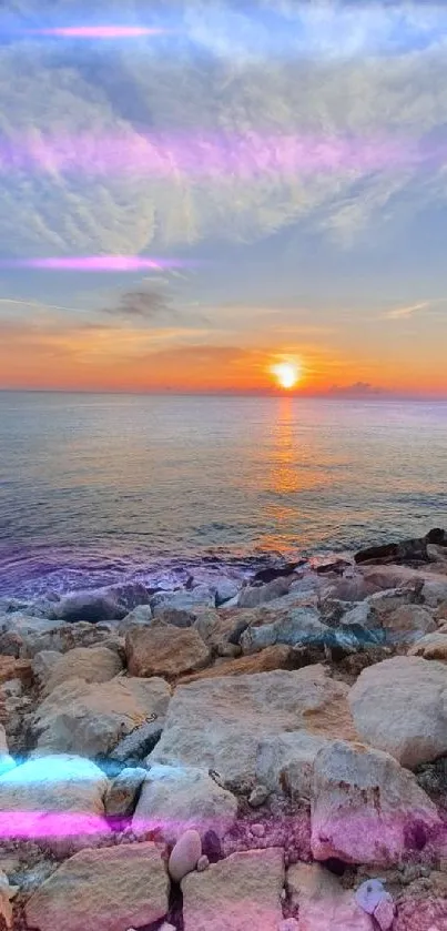 Sunset over ocean with rocky shore and vibrant sky.