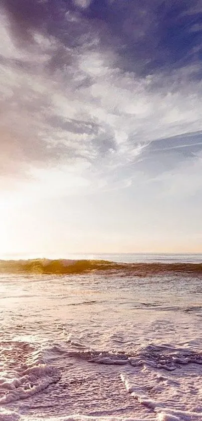 Serene ocean at sunset with soft waves and a vibrant sky.