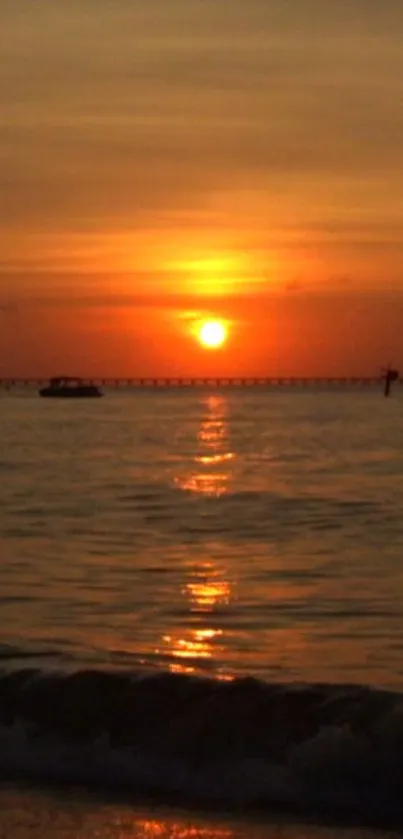 Orange sunset over ocean with reflections.