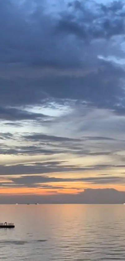 Serene sunset over tranquil ocean with vibrant sky and calm waters.