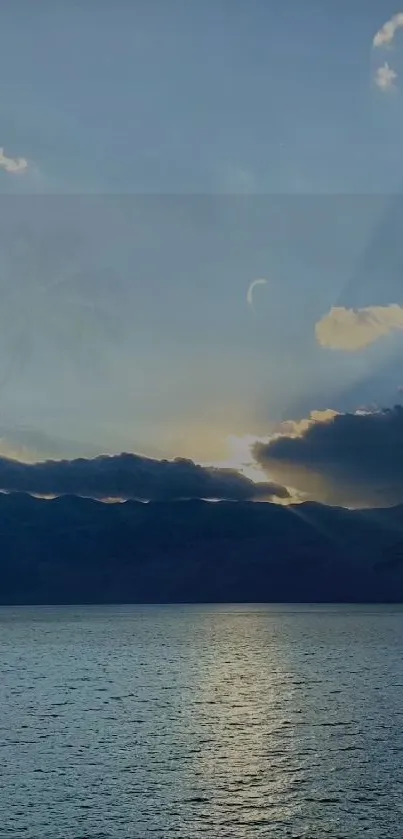 Serene sunset over ocean with clouds and sky.