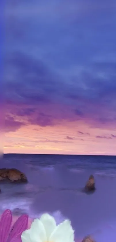 Serene ocean sunset with purple sky and flowers.