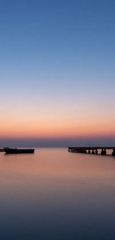 Serene ocean sunset with blue-orange gradient over calm waters.