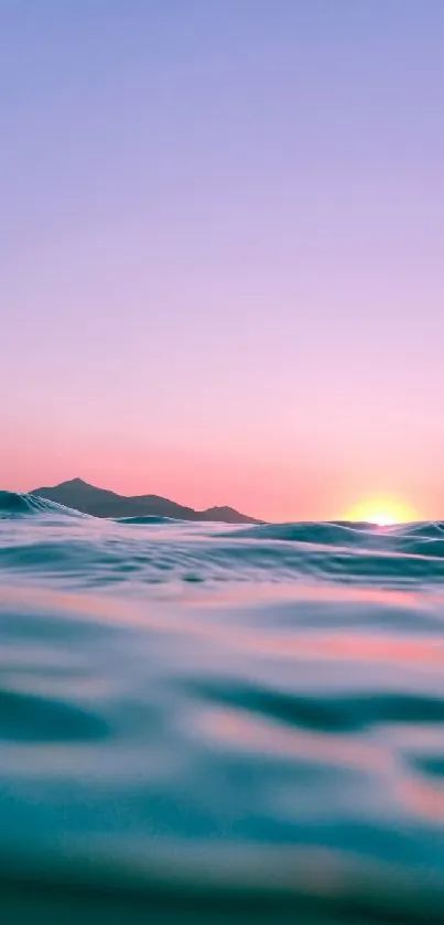 Serene ocean waves under a pink sunset sky.