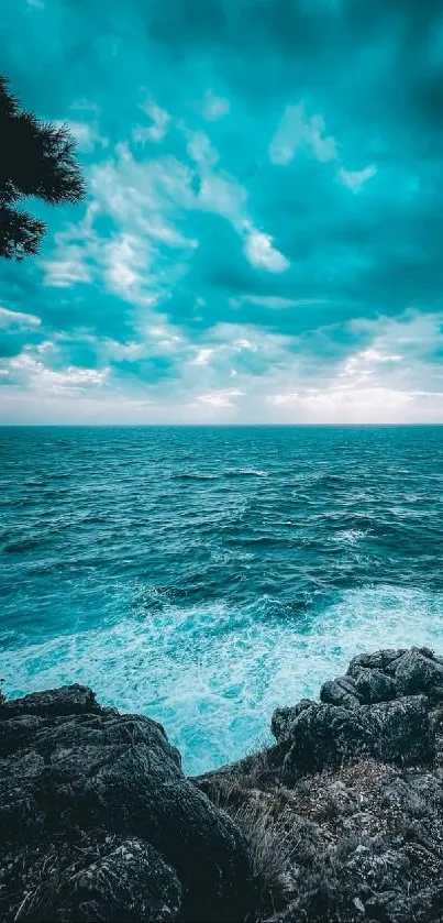 Serene turquoise ocean view with rocky shore and vibrant sky.