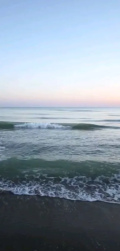 Calming ocean view with soft waves and a tranquil pastel sky.