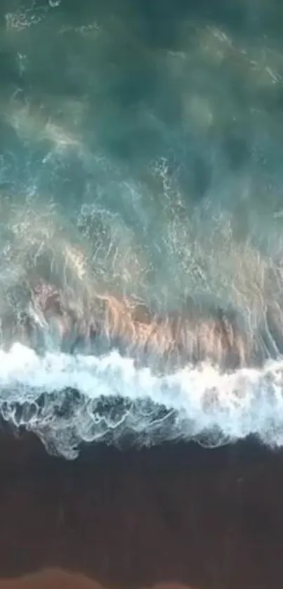 Calming aerial view of ocean waves on a beach, perfect for a serene phone wallpaper.