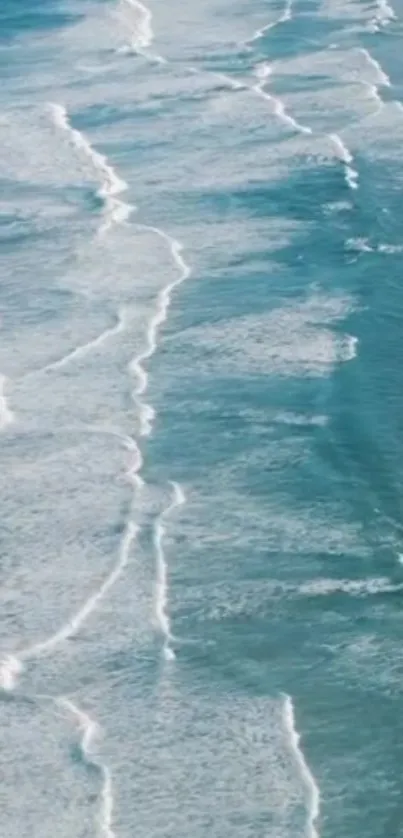 Aerial view of serene ocean waves, featuring calming blue waters.